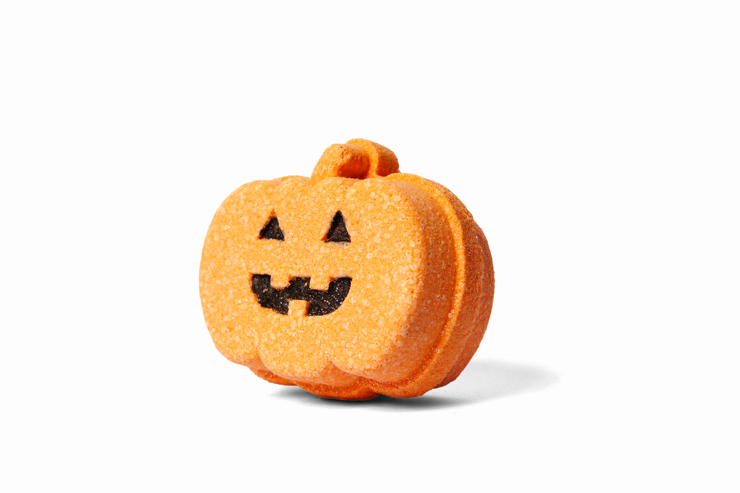 Pumpkin-shaped Jack 'o Lantern bath bomb or bath fizzer from the side.